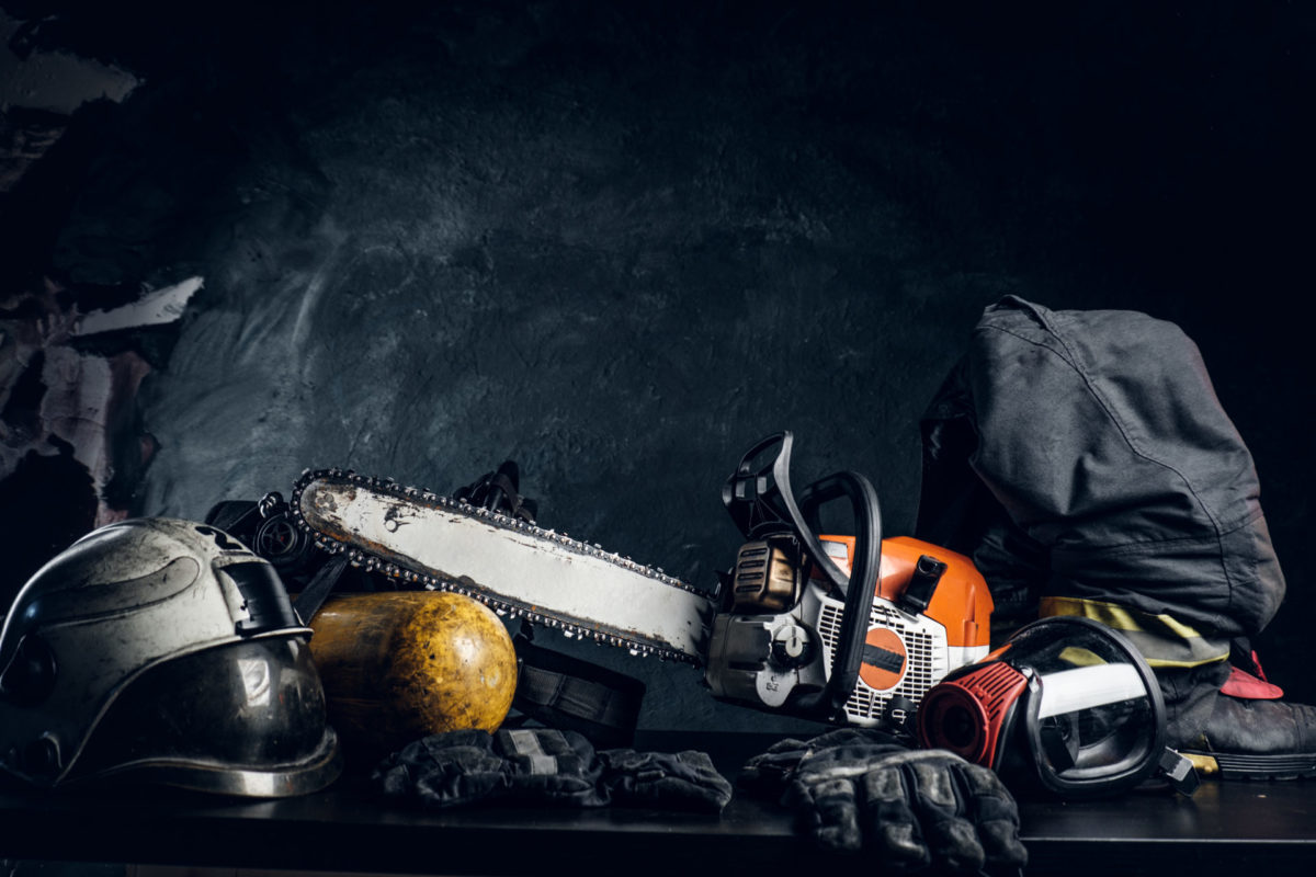 Chainsaw safety gear and tools on the black table